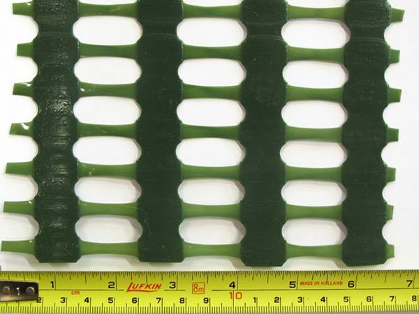 A piece of green Extruded Wind Protection Netting with 25mm × 10 mm mesh size