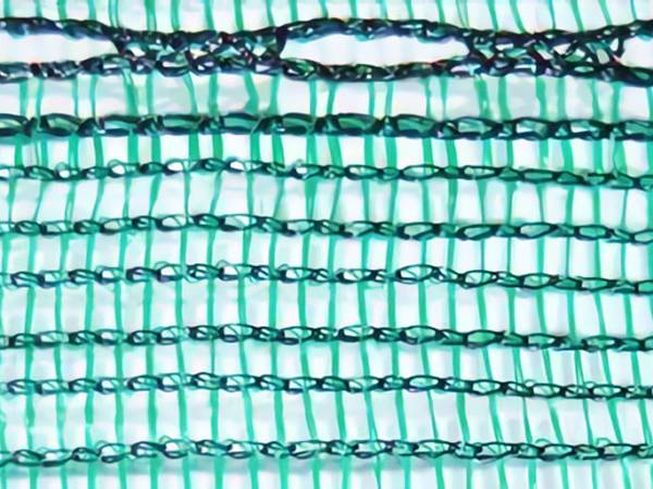 A piece of green windbreak netting with woven hole for easy install
