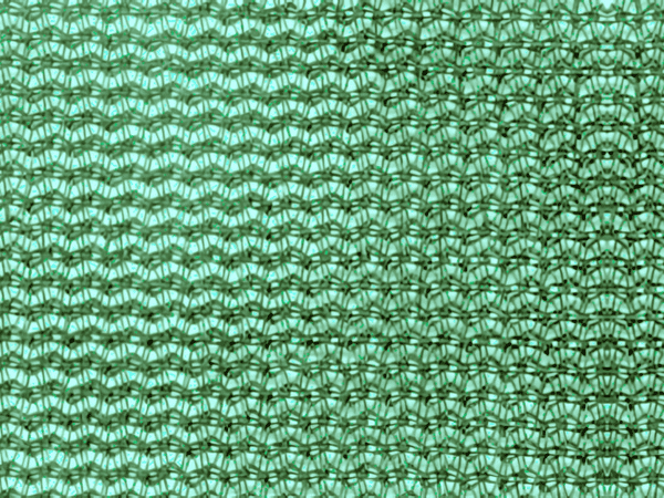 A piece of green heavy duty 270gsm knitted windbreak netting 50% wind reduction, 60% Shading