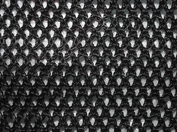 A piece of black flexible windbreak netting.