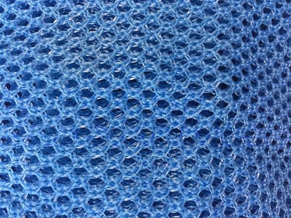 A piece of blue flexible windbreak netting.