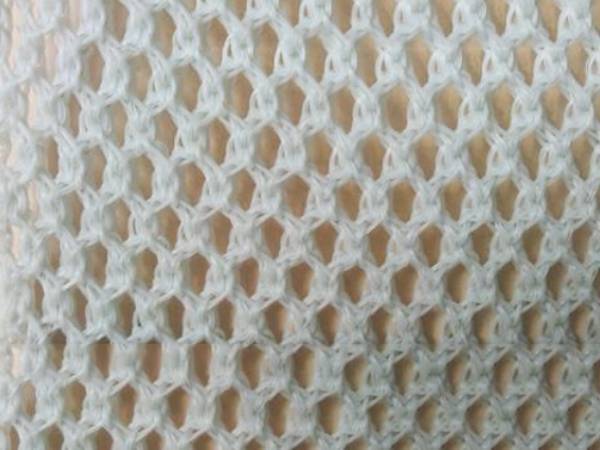 A piece of white flexible windbreak netting.