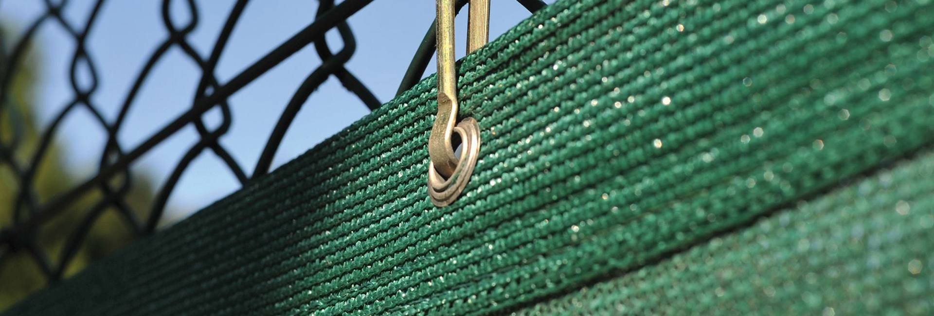 HDPE mono-filament knitted windbreak netting is hanging with metal hooks.